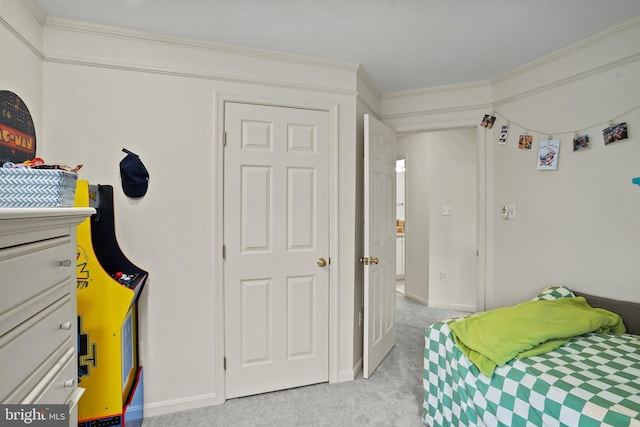 bedroom featuring light colored carpet, crown molding, and baseboards