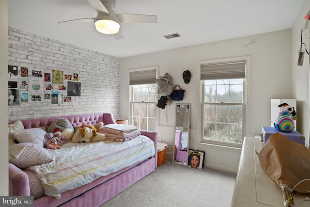 bedroom featuring visible vents, baseboards, brick wall, ceiling fan, and carpet floors