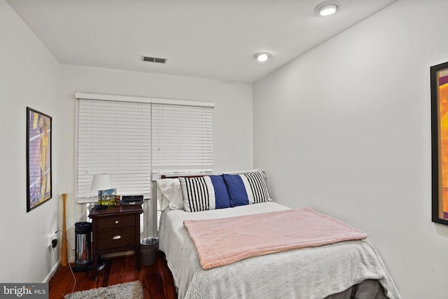 bedroom featuring visible vents and wood finished floors