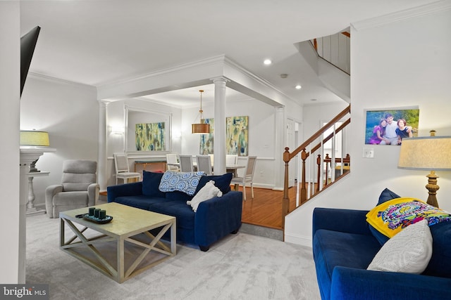 living area with decorative columns, stairs, crown molding, and recessed lighting