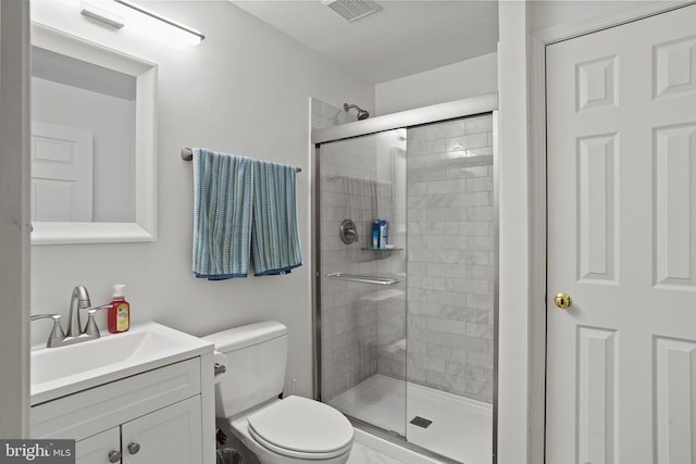 full bathroom with toilet, vanity, a shower stall, and visible vents