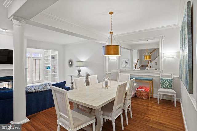 dining space featuring crown molding, stairway, ornate columns, and wood finished floors