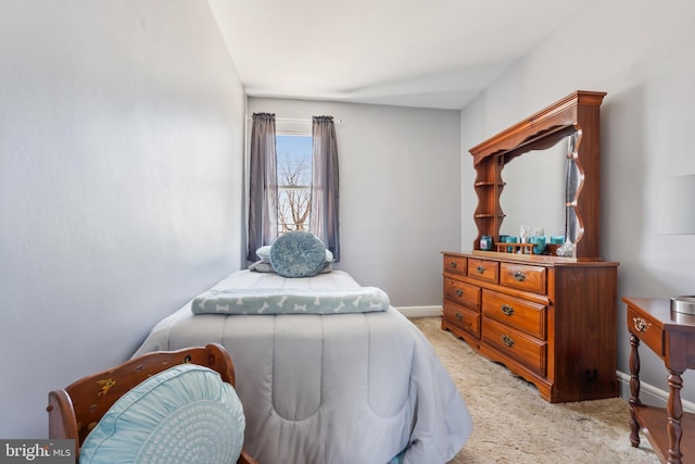 bedroom featuring baseboards and light colored carpet