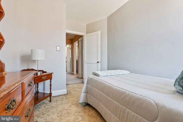 bedroom featuring baseboards and light colored carpet