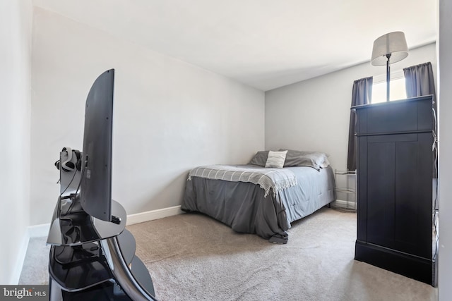 bedroom featuring carpet flooring and baseboards