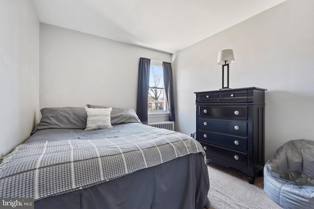 bedroom with carpet flooring and radiator