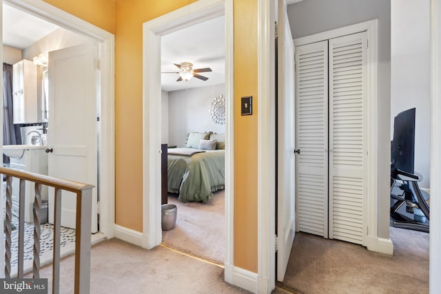 hall with carpet floors and baseboards