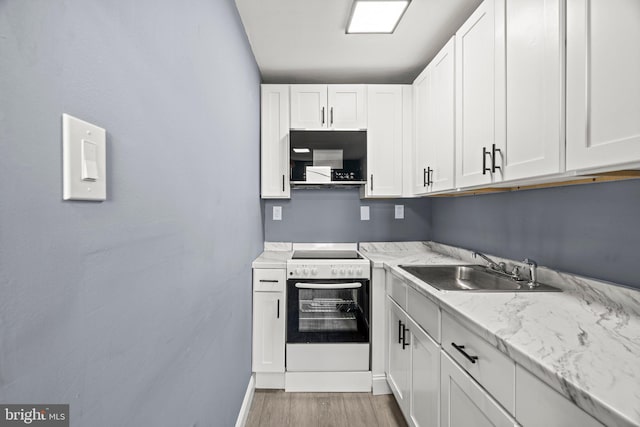 kitchen featuring a sink, light wood-type flooring, white cabinetry, and electric range oven