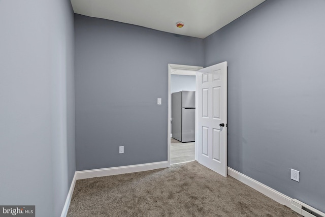 unfurnished room with carpet and baseboards