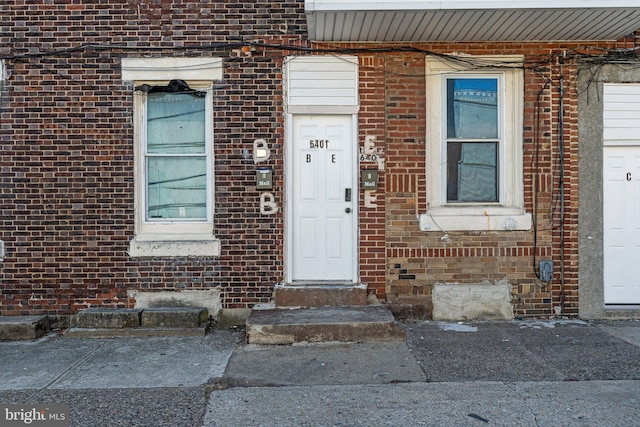 property entrance with brick siding