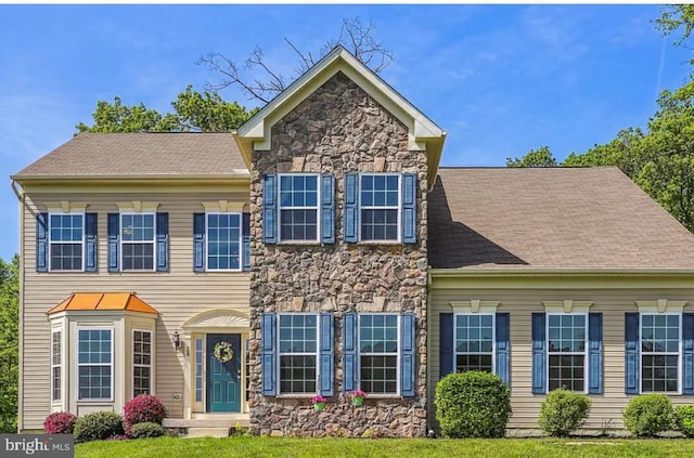 traditional home with stone siding