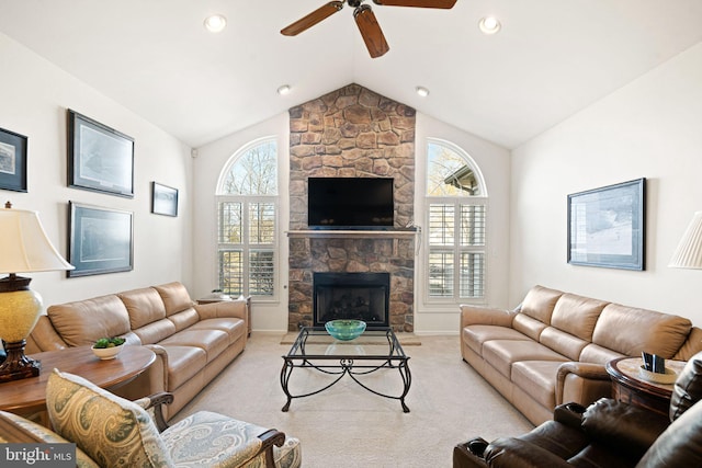 living area featuring lofted ceiling, recessed lighting, light colored carpet, ceiling fan, and a stone fireplace