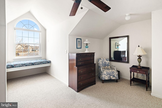 living area with a ceiling fan, baseboards, vaulted ceiling, and carpet flooring