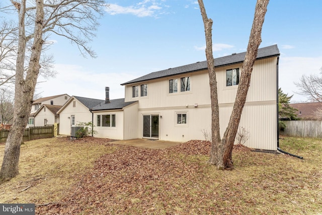 rear view of property with a patio and fence