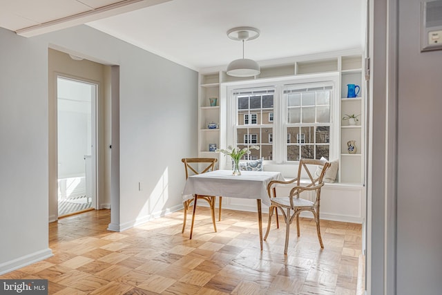 dining room featuring baseboards and built in features