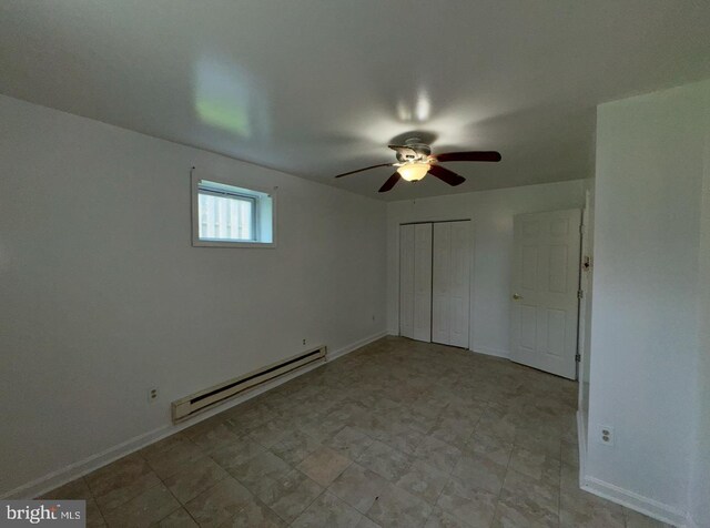 unfurnished bedroom with baseboards, a closet, and a baseboard radiator