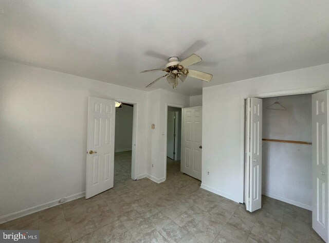 unfurnished bedroom with baseboards, a ceiling fan, and a closet