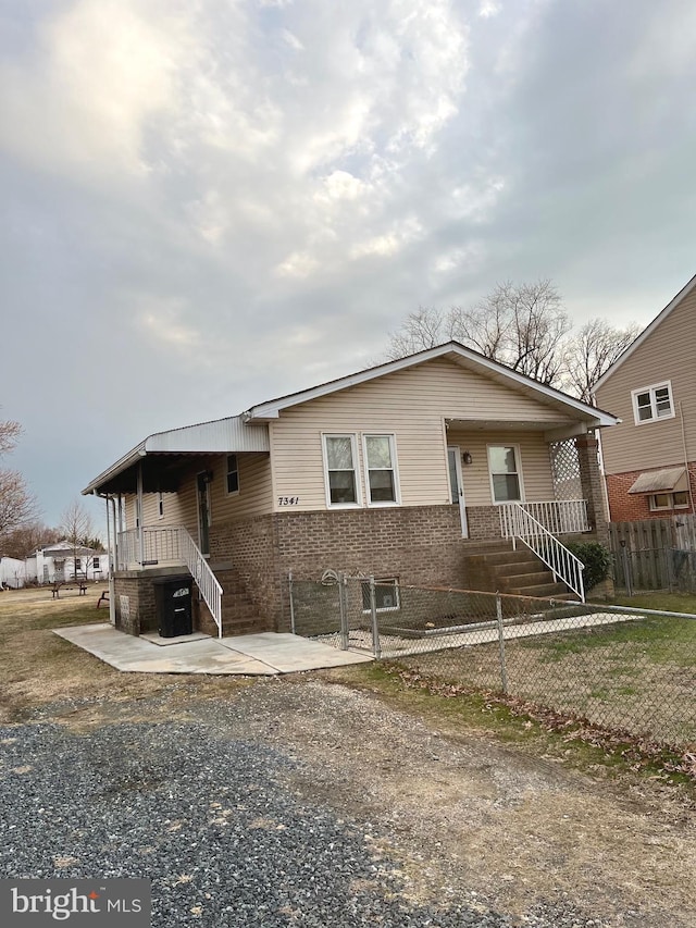 view of front of house featuring a fenced front yard and brick siding