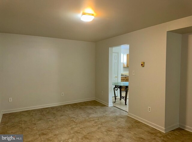 empty room featuring baseboards