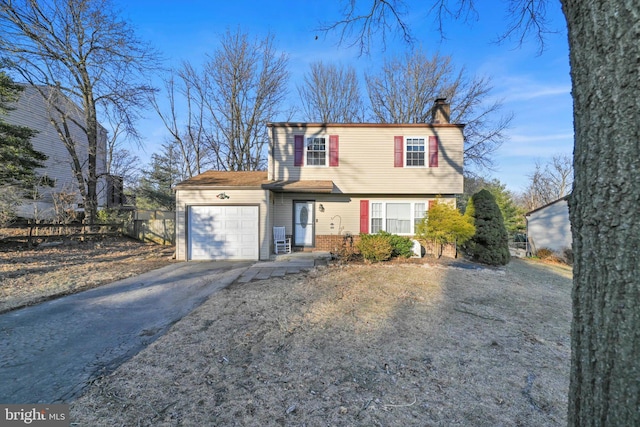 view of front of home featuring a garage, driveway, and a chimney