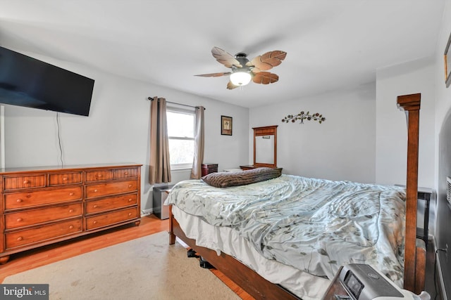 bedroom with light wood-style flooring and a ceiling fan