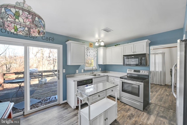 kitchen featuring visible vents, appliances with stainless steel finishes, white cabinets, and a sink