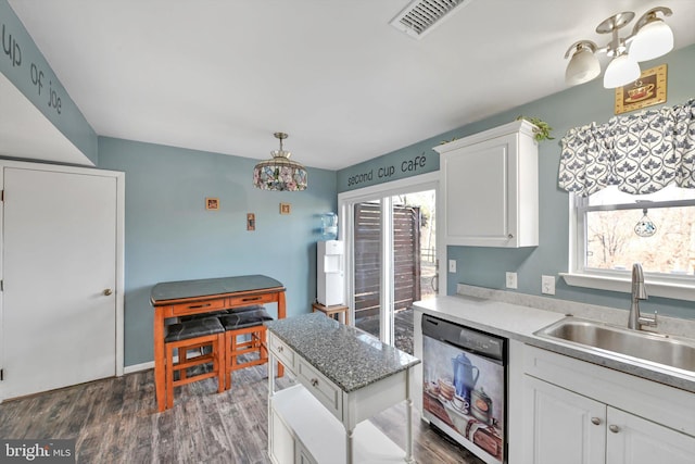 kitchen featuring dishwasher, dark wood-type flooring, a sink, and a wealth of natural light