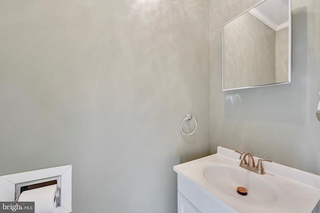 bathroom with ornamental molding and vanity