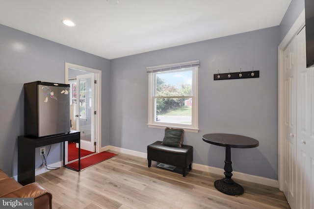 sitting room featuring light wood finished floors, baseboards, and recessed lighting