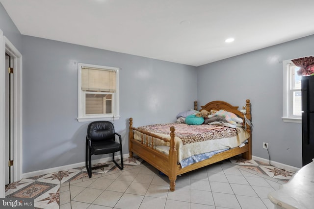 bedroom with light tile patterned floors, baseboards, and recessed lighting