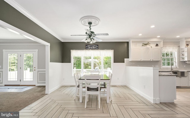 dining space featuring a wainscoted wall, ornamental molding, plenty of natural light, and recessed lighting