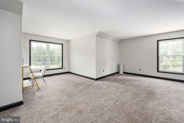 empty room featuring carpet floors and baseboards