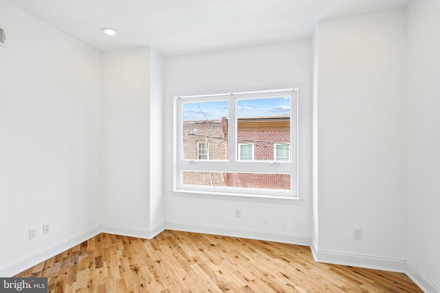 unfurnished room featuring baseboards, recessed lighting, and light wood-style floors