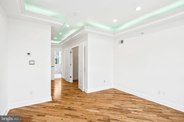 unfurnished room with baseboards, ornamental molding, recessed lighting, and light wood-style floors