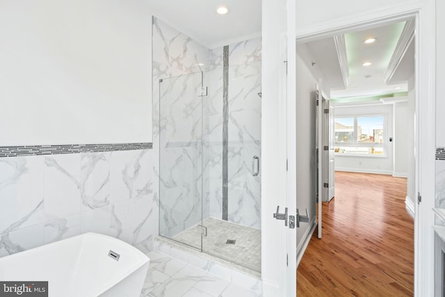 bathroom featuring marble finish floor, tile walls, a marble finish shower, recessed lighting, and a freestanding bath