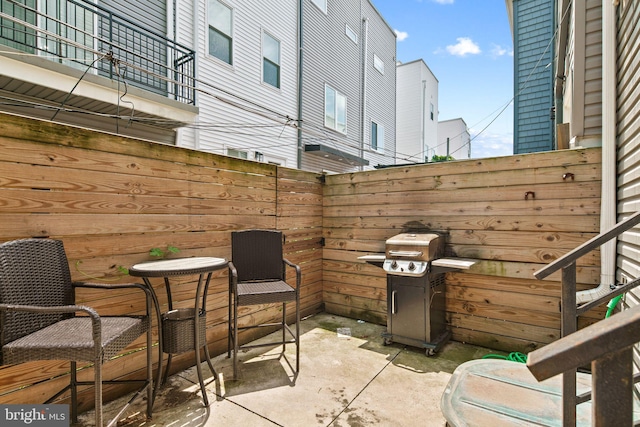 view of patio featuring a grill