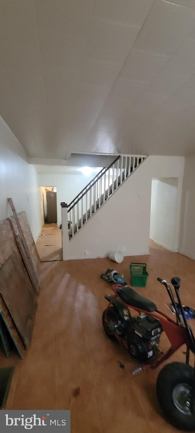 staircase featuring lofted ceiling and carpet flooring