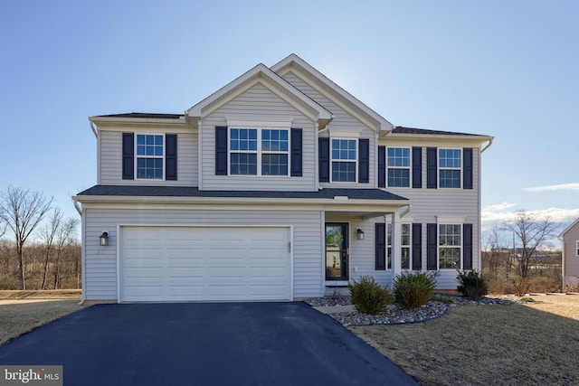 view of front of home with a garage and aphalt driveway