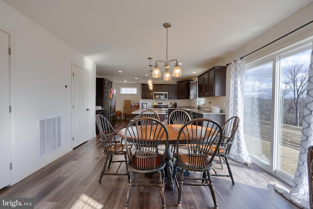 dining space featuring visible vents, dark wood finished floors, and recessed lighting