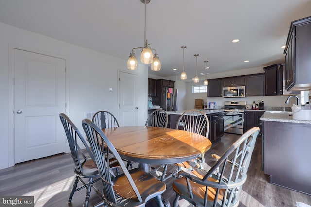 dining room with recessed lighting and wood finished floors