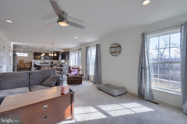 living room with visible vents, baseboards, light colored carpet, ceiling fan, and recessed lighting