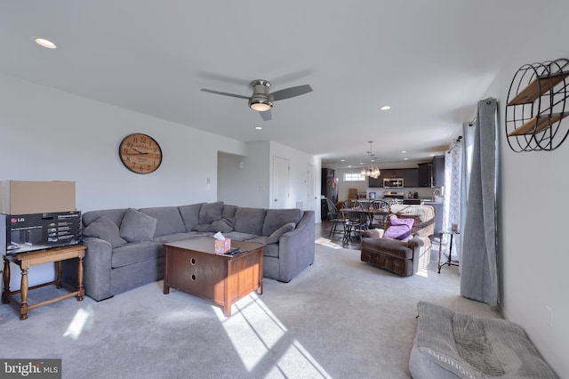 living area with light carpet, a ceiling fan, and recessed lighting