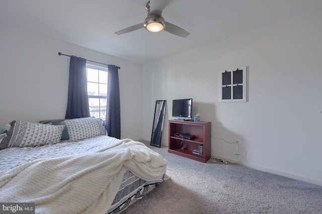 carpeted bedroom with a ceiling fan and baseboards