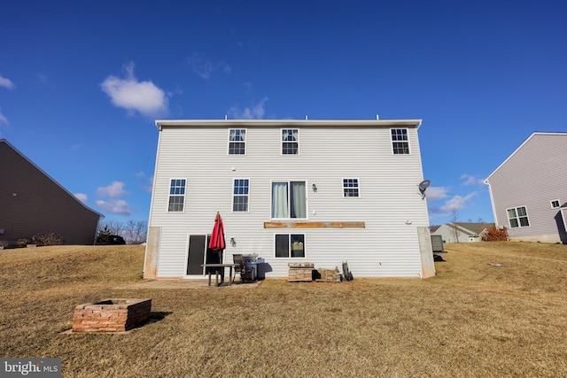 back of property featuring a lawn