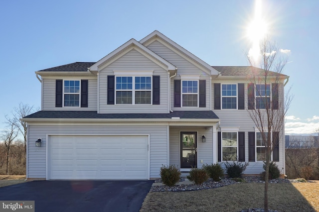 view of front of property featuring a garage and driveway