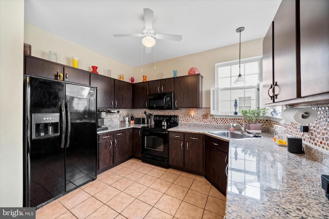 kitchen featuring decorative light fixtures, tasteful backsplash, a sink, dark brown cabinets, and black appliances