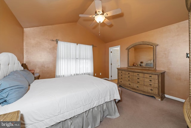 carpeted bedroom with baseboards, vaulted ceiling, and a ceiling fan