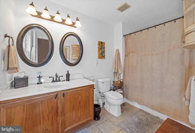 bathroom with curtained shower, visible vents, toilet, vanity, and tile patterned floors