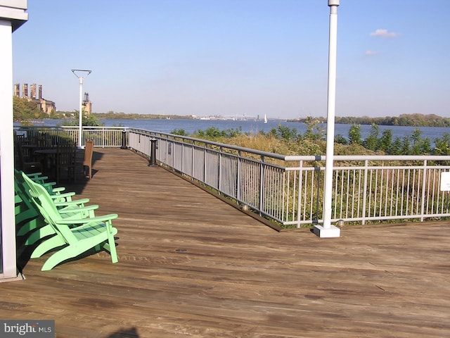 wooden deck featuring a water view