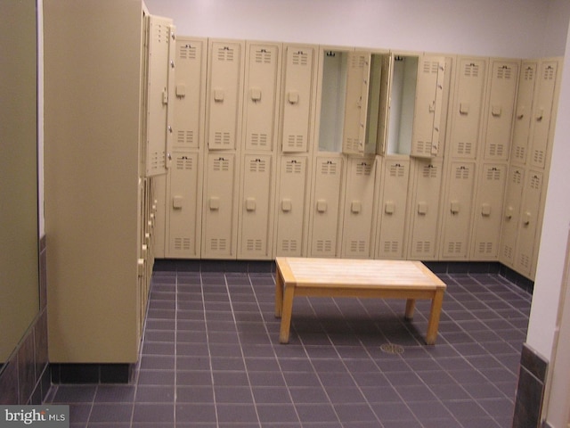 interior space featuring mail area and dark tile patterned floors